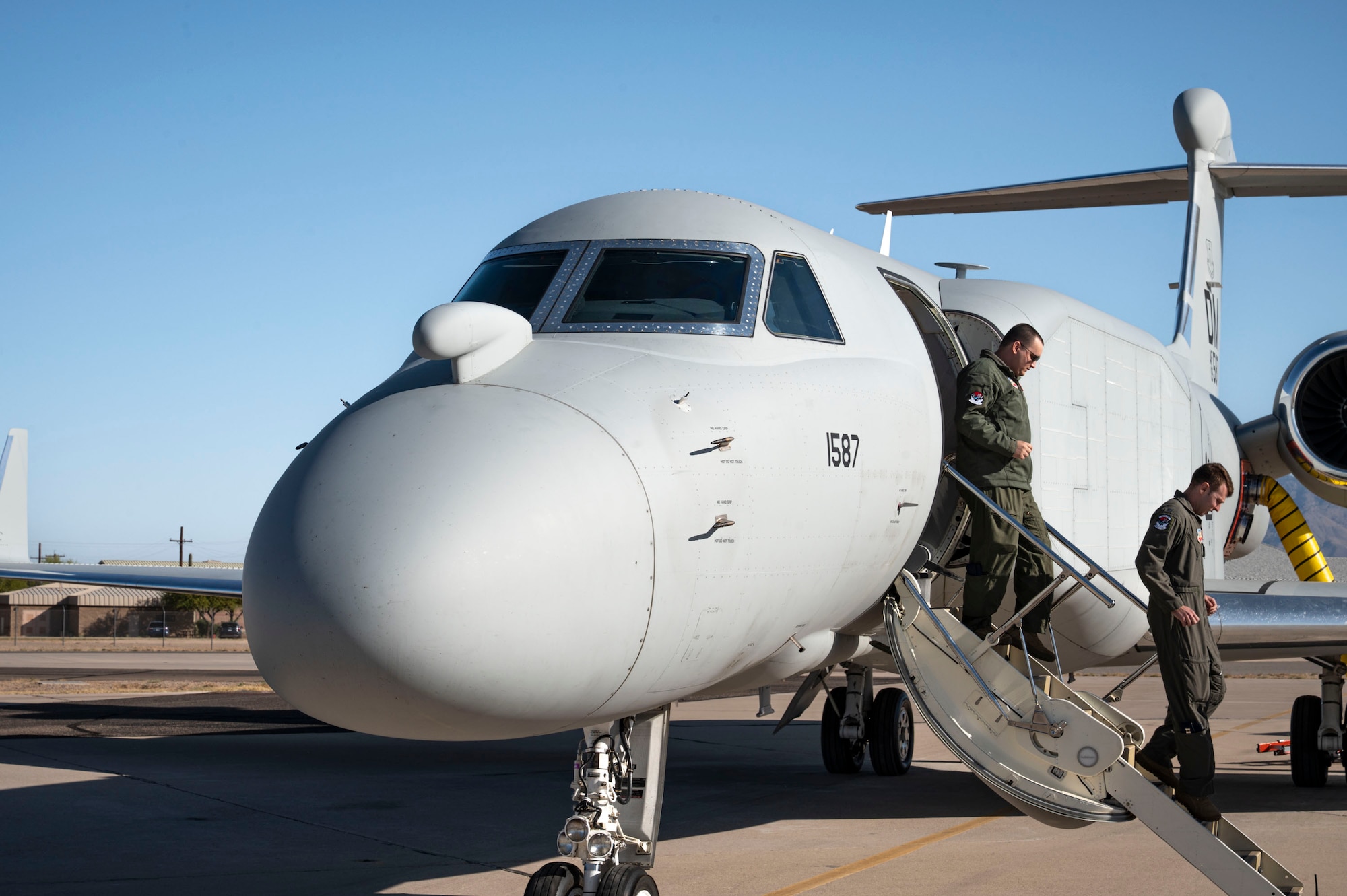 U.S. Airmen assigned to the 43rd Electronic Combat Squadron disembark from an EA-37B Compass Call aircraft prior to its first official mission training sortie flight at Davis-Monthan Air Force Base, Arizona, May 2, 2025. The EA-37B features classified modifications to its mission system, designed to enhance precision and increase target capacity. (U.S. Air Force photo by Airman Samantha Melecio)