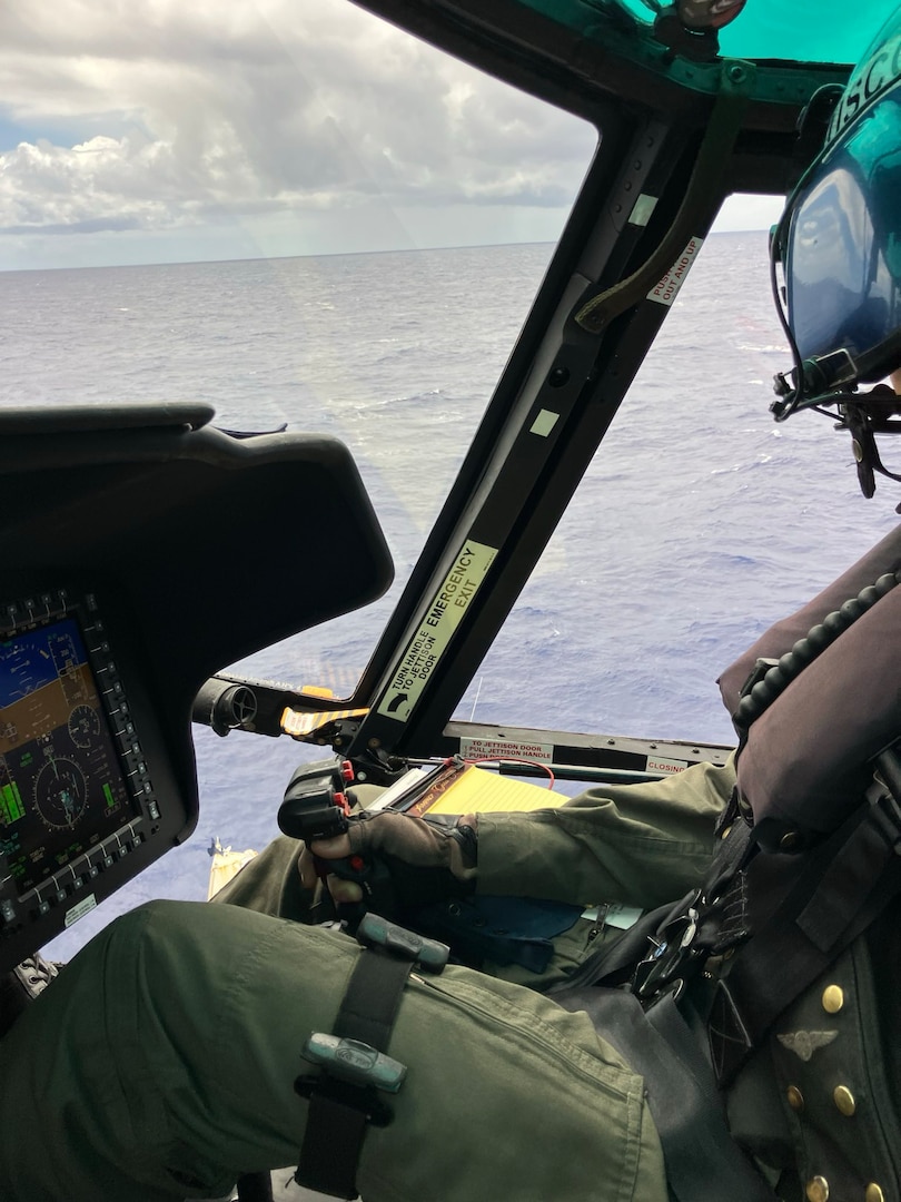A pilot aboard an MH-65 Dolphin helicopter prepares to medevac an ailing captain from his vessel 80 miles offshore Hilo, Hawaii, May 9, 2025. The crew medevaced a 68-year-old man who had reportedly been experiencing symptoms such as abdominal pain and fever. (U.S. Coast Guard photo, courtesy Air Station Barbers Point)