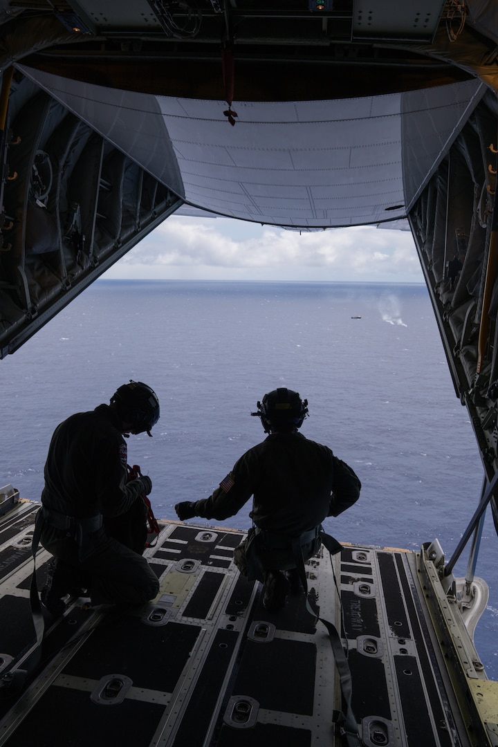 Crew members aboard an HC-130 Hercules airplane from Coast Guard Air Station Barbers Point work on the ramp of the aircraft following the drop of medication to a commercial fishing vessel 675 miles offshore Hilo, Hawaii, May 7, 2025. The captain of the vessel, a 68-year-old man, had reportedly been experiencing symptoms such as fever and severe abdominal pain. (U.S. Coast Guard photo by Petty Officer 3rd Class Avery Tibbets)