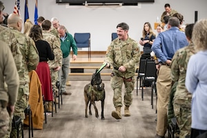 Callie, the only certified search-and-rescue dog in the Department of Defense, is ready for some well-earned play time at the conclusion of her retirement ceremony at the Kentucky Air National Guard Base in Louisville, Ky., Jan. 24, 2025. Over the course of more than six years with the 123rd Special Tactics Squadron, Callie served on numerous exercises and six real-world deployments, searching for survivors in the aftermath of floods, tornadoes, an avalanche, a collapsed coal mine tipple and multiple demolished buildings. (U.S. Air National Guard photo by Dale Greer)