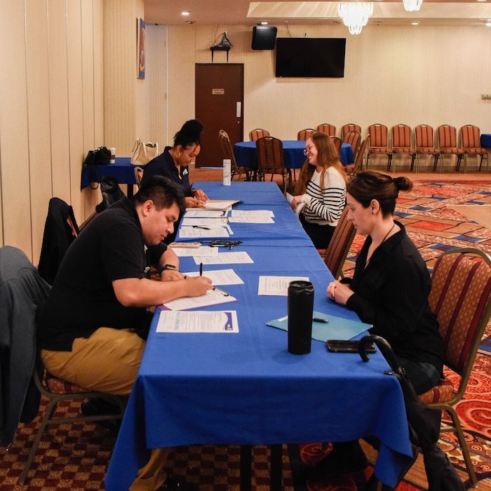 Staff members of the Commander, Fleet Activities Yokosuka (CFAY) Child and Youth Program host a job fair for dependents at the base Officer’s Club.