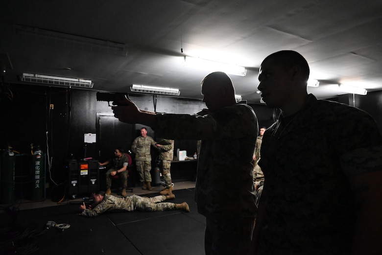 An Airman shoots at a virtual target.