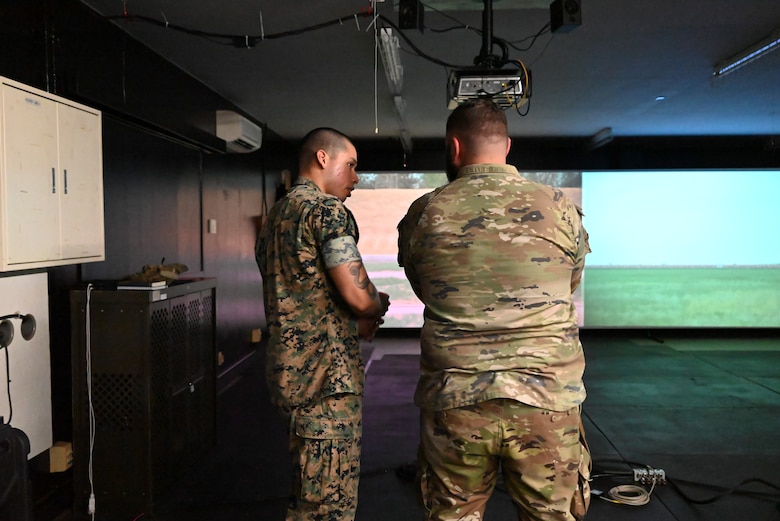 A Marine talks to an Airman.