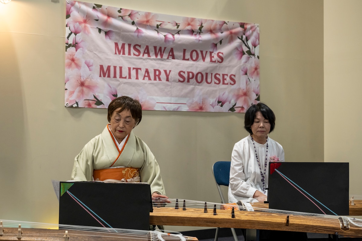 Musicians perform traditional Japanese music on a koto during Spouse Appreciation Day.