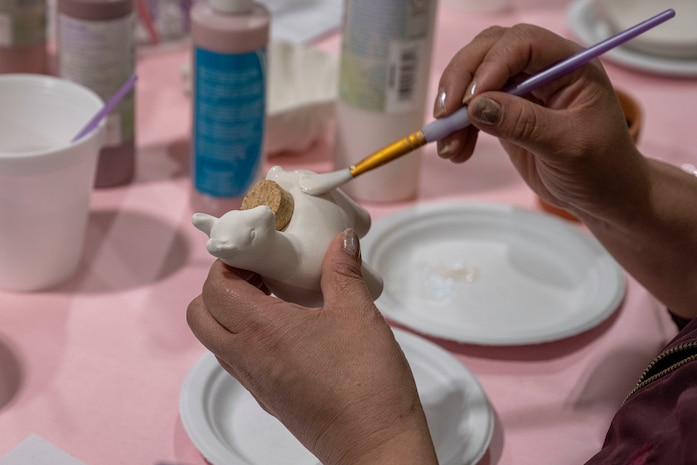 An attendee participates in arts and crafts during Spouse Appreciation Day.