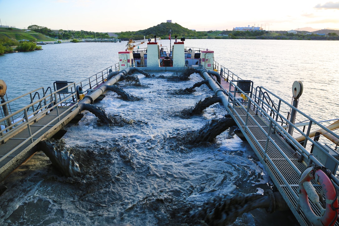 U.S. Army Corps of Engineers, (USACE), Dredge MURDEN pumps sand and slurry materials during 24/7 dredge operations in Naval Station Guantanamo Bay, Cuba, April 23, 2025. Dredge MURDEN is clearing critical shoaling by dredging areas that will maintain safe and efficient navigation conditions for military and commercial vessels in the harbor. (USACE Photo by Mark Rankin)