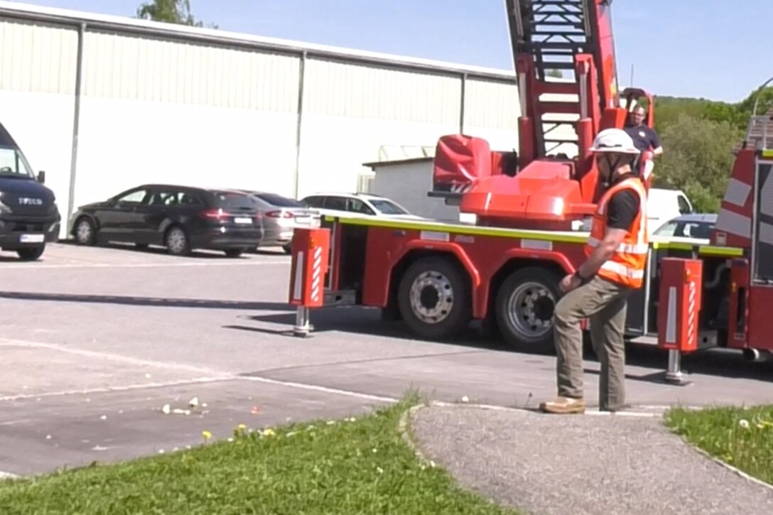 man standing by firetruck