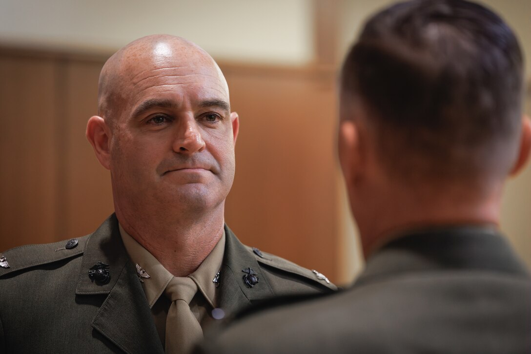 U.S. Marine Corps Col. Joseph A. Katz, the chief of staff for Marine Forces Reserve, steps up to a stage for a frocking ceremony at Marine Corps Support Facility, New Orleans, May 9, 2025. Frocking is a tradition where Marines are advanced to the next pay grade, assuming the title and the responsibilities prior to their official date of promotion. Katz was frocked to the rank of brigadier general. (U.S. Marine Corps photo illustration by Lance Cpl. Van Hoang)
