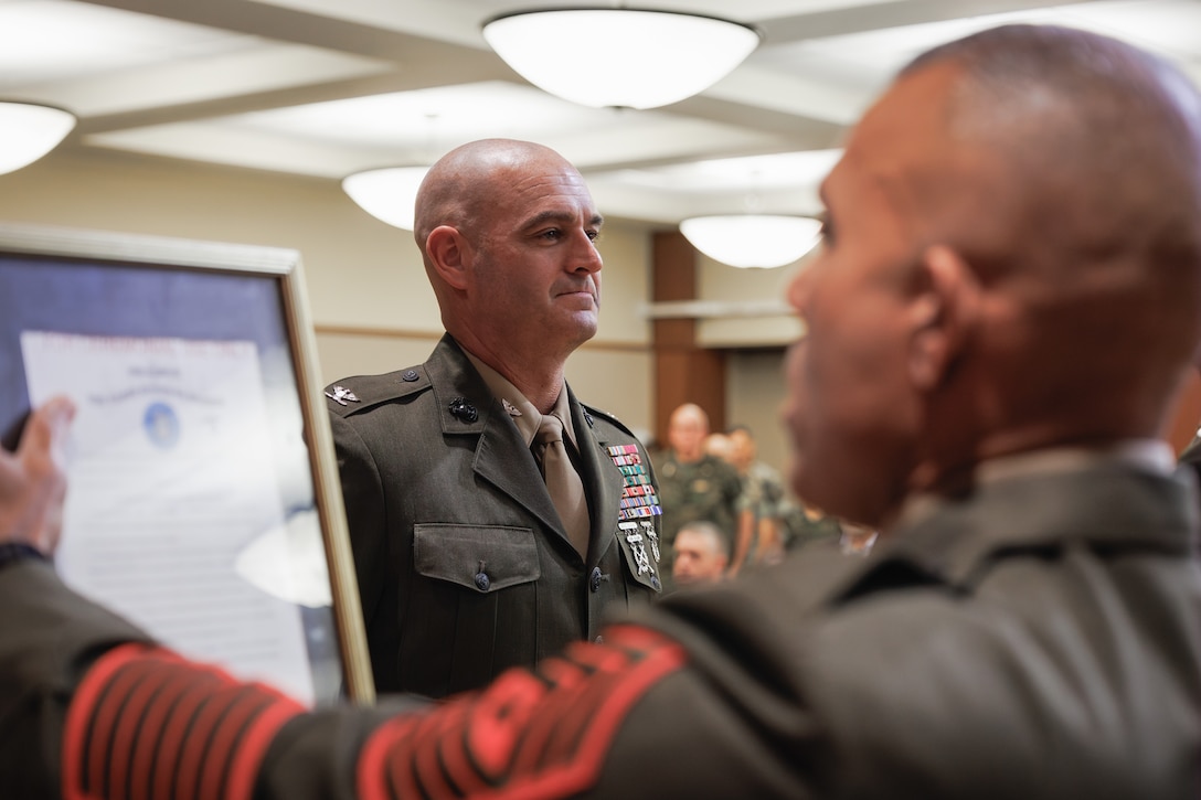 U.S. Marine Corps Sergeant Maj. Edwin A. Mota, command senior enlisted leader for Marine Forces Reserve, reads a promotion warrant during the frocking ceremony of Col. Joseph A. Katz, the chief of staff for Marine Forces Reserve, at Marine Corps Support Facility, New Orleans, May 9, 2025. Frocking is a tradition where Marines are advanced to the next pay grade, assuming the title and the responsibilities prior to their official date of promotion. Katz was frocked to the rank of brigadier general. (U.S. Marine Corps photo by Lance Cpl. Van Hoang)