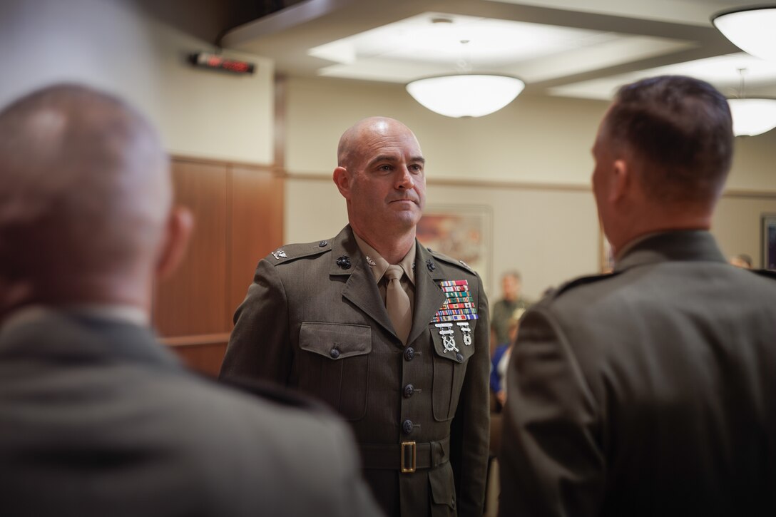 U.S. Marine Corps Col. Joseph A. Katz, the chief of staff for Marine Forces Reserve, steps up to a stage for a frocking ceremony at Marine Corps Support Facility, New Orleans, May 9, 2025. Frocking is a tradition where Marines are advanced to the next pay grade, assuming the title and the responsibilities prior to their official date of promotion. Katz was frocked to the rank of brigadier general. (U.S. Marine Corps photo illustration by Lance Cpl. Van Hoang)