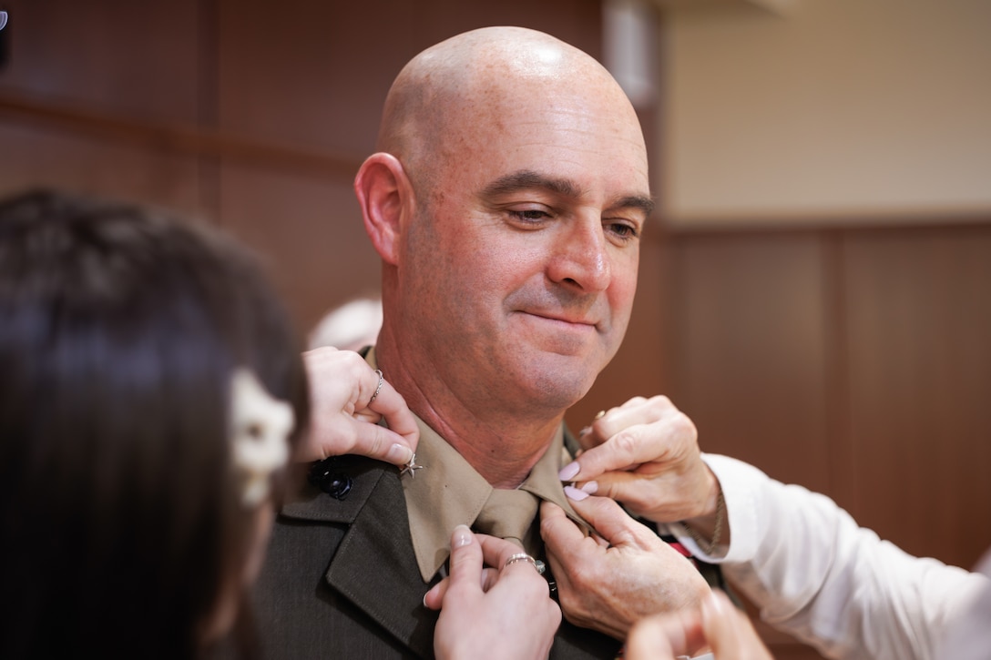 U.S. Marine Corps Col. Joseph A. Katz, center, the chief of staff for Marine Forces Reserve, is pinned by family and friends during his frocking ceremony at Marine Corps Support Facility, New Orleans, May 9, 2025. Frocking is a tradition where Marines are advanced to the next pay grade, assuming the title and the responsibilities prior to their official date of promotion. Katz was frocked to the rank of brigadier general. (U.S. Marine Corps photo by Lance Cpl. Van Hoang)