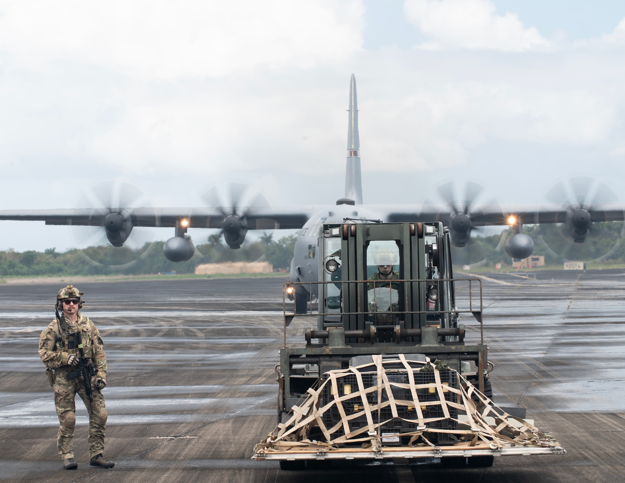 U.S. Air Force Airmen from the 133rd Contingency Response Flight, Minnesota Air National Guard, wait to load cargo onto a C-130 Hercules in Ceiba, Puerto Rico, April 8, 2025.