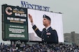 Maj. Scott D. Hager, 85th U.S. Army Reserve Support Command, waves to cheering baseball fans, on the jumbotron, during the Military Salute at the Chicago Cubs Hometown Opener game versus the San Diego Padres on April 4, 2025, at Wrigley Field.