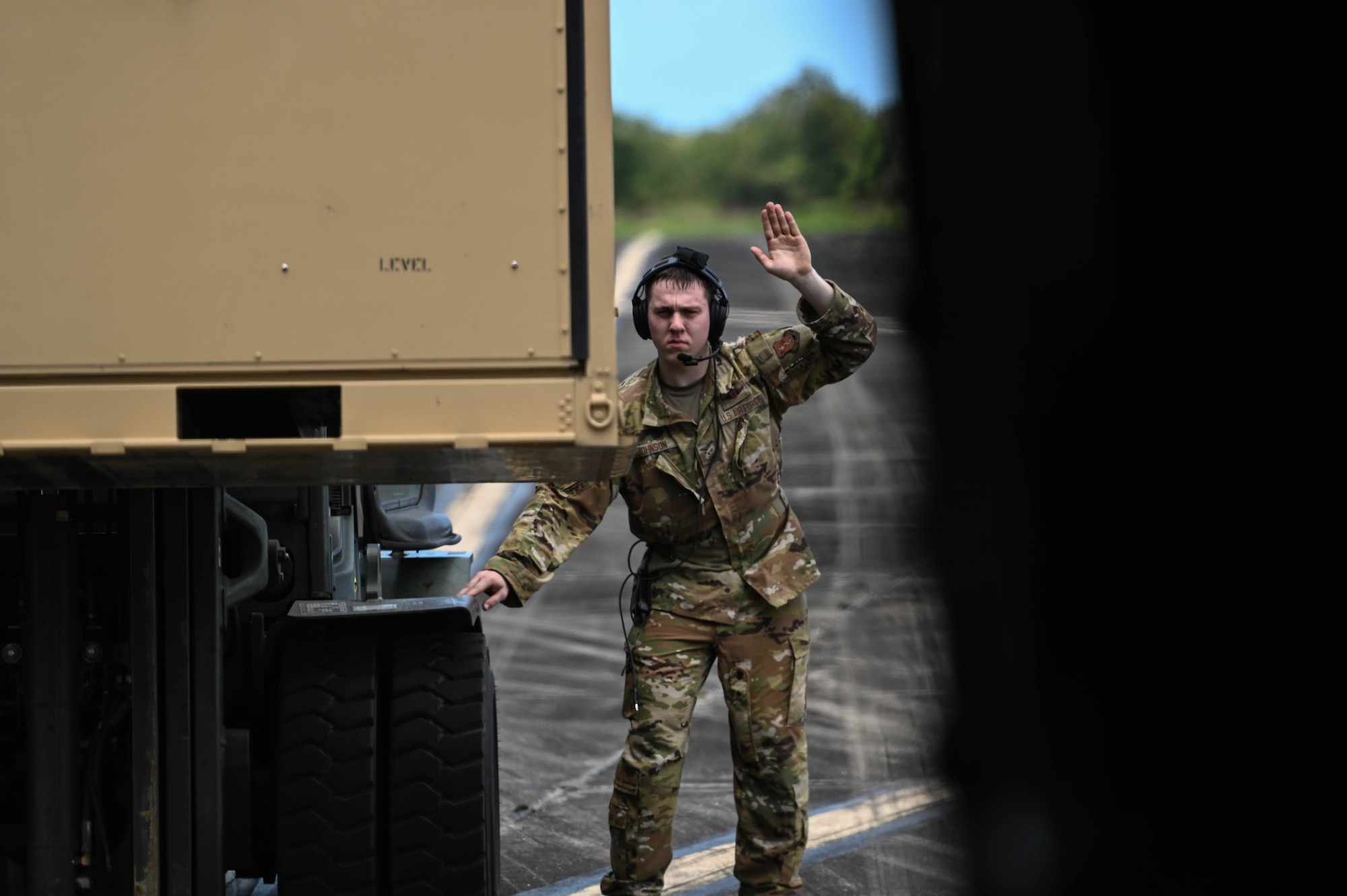 U.S. Air Force Senior Airman Zaccaria Johnson, from the 109th Airlift Squadron, Minnesota Air National Guard, directs a cargo container onto a C-130 Hercules in Ceiba, Puerto Rico, April 10, 2025.
