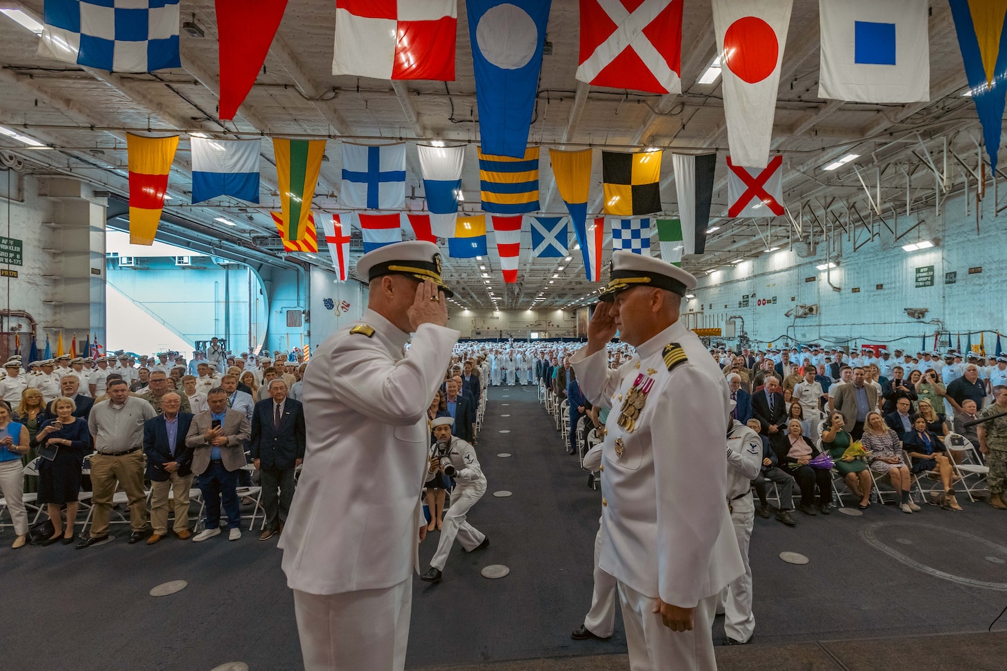 Rear Adm. Richard Burgess, left, is relieved by Capt. David Skarosi as commanding officer of USS Gerald R. Ford (CVN 78) during a change of command ceremony in the ship’s hangar bay, May 12.