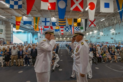 Rear Adm. Richard Burgess, left, is relieved by Capt. David Skarosi as commanding officer of USS Gerald R. Ford (CVN 78) during a change of command ceremony in the ship’s hangar bay, May 12.