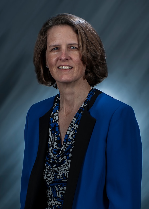 A smiling woman in a business suit.