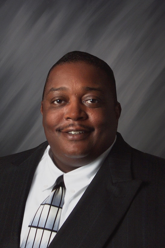 A smiling man in a business suit.