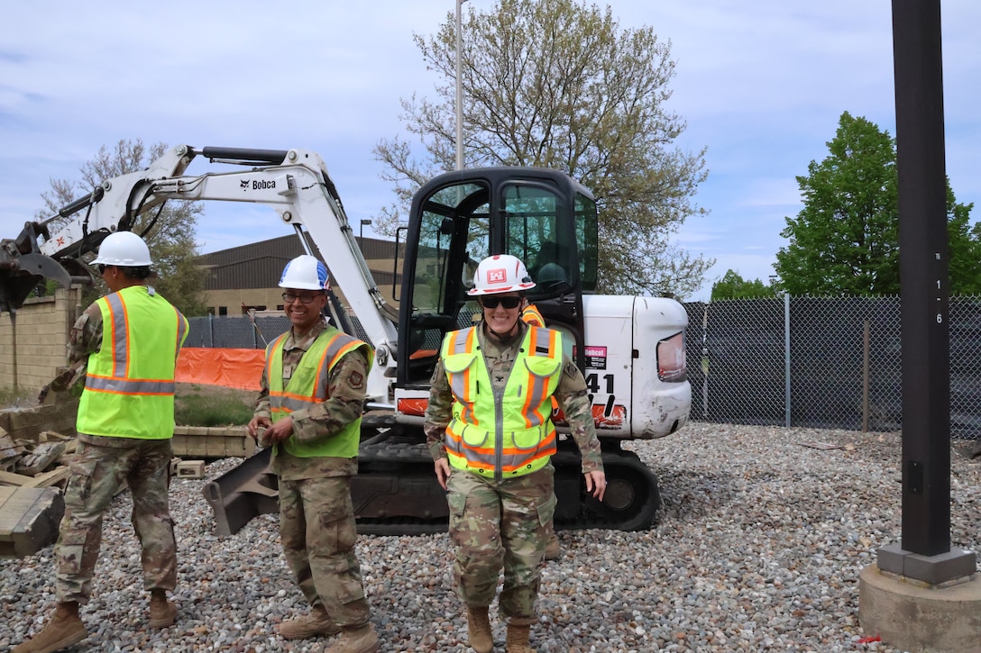 Walking through debris after ceremonial groundbreaking.