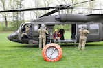 New York Army National Guard aircrews assigned to the 3rd Battalion, 142nd Aviation Regiment, prepare New York State Forest Rangers for familiarization training with water buckets for aerial firefighting in Schuylerville, New York, May 8, 2025. The New York Army National Guard aircrews trained alongside Department of Environmental Conservation Forest Rangers to better prepare for crew coordination and communications techniques in water drops to battle wildfires.