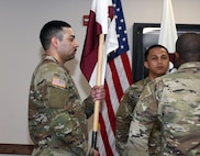 Staff Sgt. Tereso Hernandez, left, takes the unit colors as he assumes responsibility as detachment sergeant for the U.S. Army Medical Materiel Agency’s Headquarters and Headquarters Detachment during a change of responsibility ceremony May 2 at Fort Detrick, Maryland.