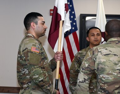 Staff Sgt. Tereso Hernandez, left, takes the unit colors as he assumes responsibility as detachment sergeant for the U.S. Army Medical Materiel Agency’s Headquarters and Headquarters Detachment during a change of responsibility ceremony May 2 at Fort Detrick, Maryland.