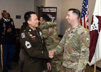 Sgt. 1st Class Adrian Doll, right, shakes hands with Master Sgt. Peung Kim following a U.S. Army Medical Materiel Agency detachment change of responsibility ceremony May 2 at Fort Detrick, Maryland. Doll passed responsibility as detachment sergeant to Staff Sgt. Tereso Hernandez during the event.
