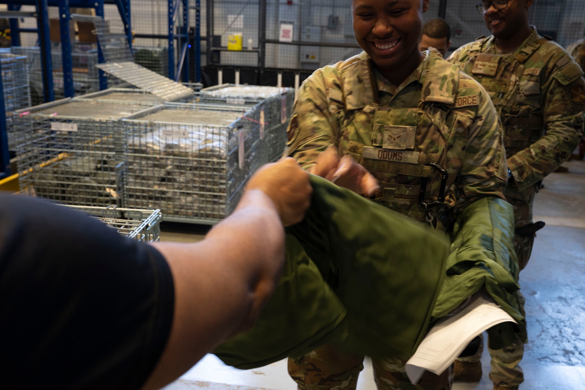 Airman reaches hand out to accept equipment issue.