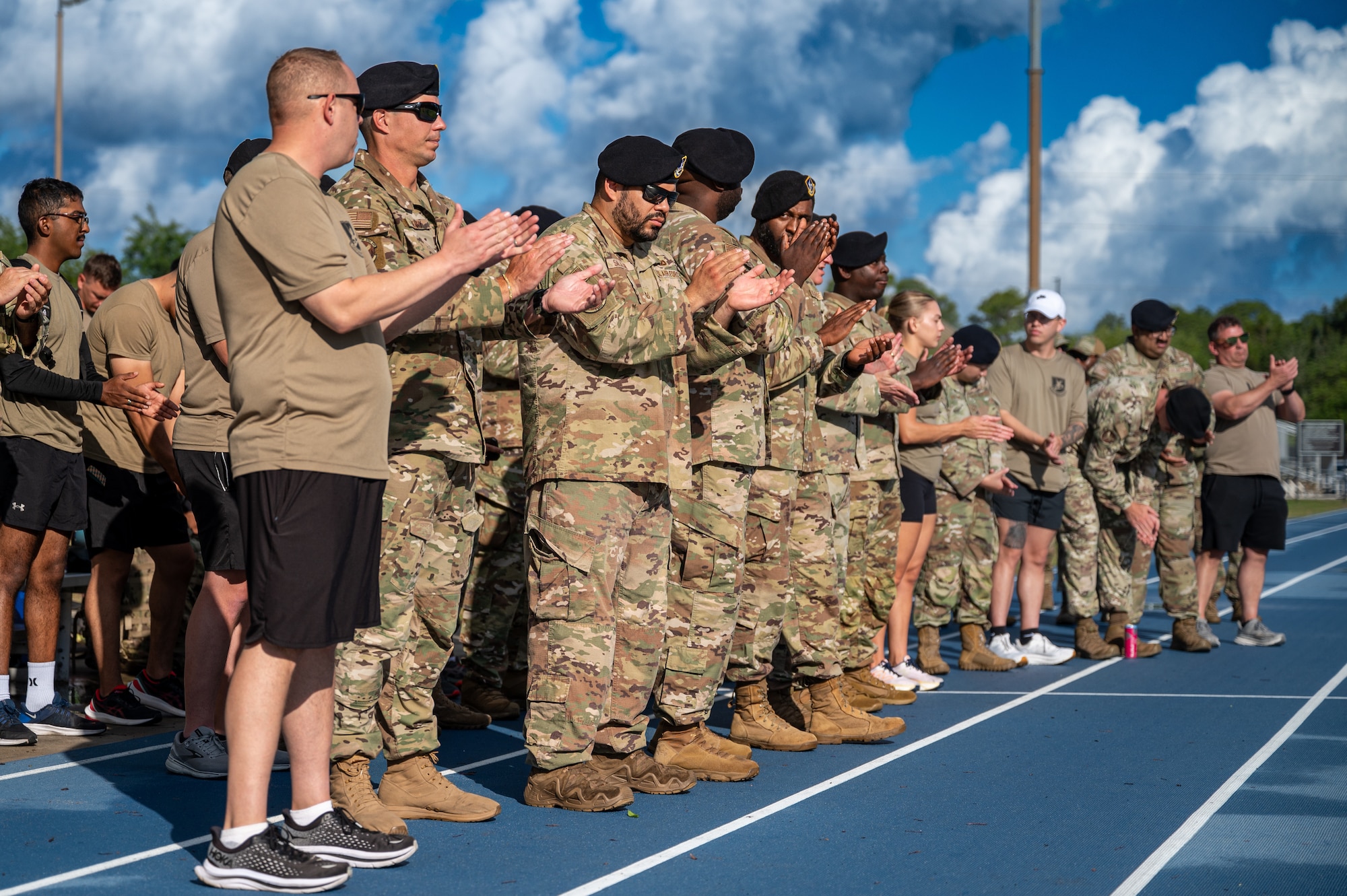 Airmen watching the ceremony clap during a speech.