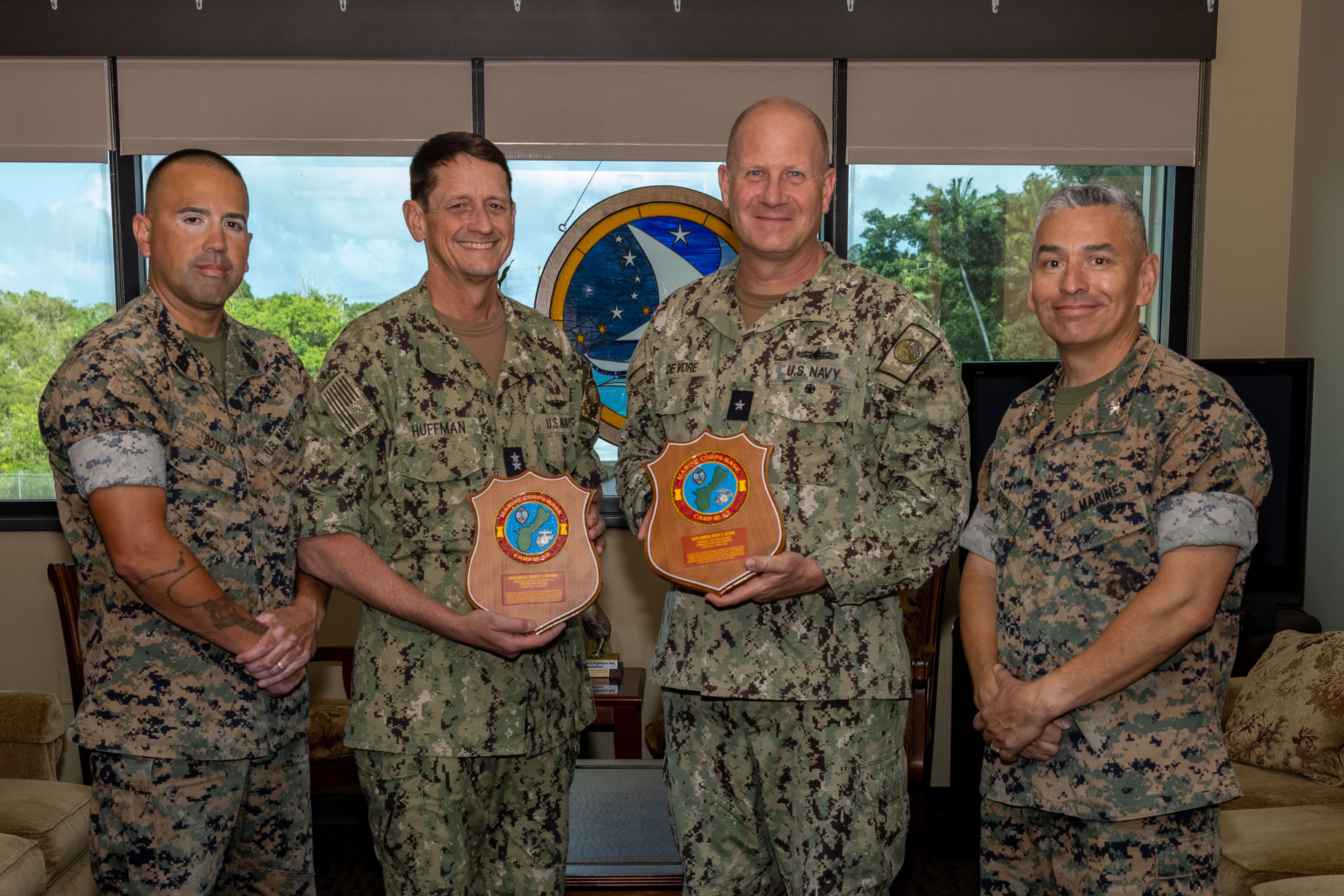 U.S. Marine Corps senior leaders with Marine Corps Base Camp Blaz and U.S. Navy Rear Adm. Gregory Huffman, commander, Joint Task Force-Micronesia and Rear Adm. Brent DeVore, commander, Joint Region Marianas, pose for a photo with the plaques presented by MCB Camp Blaz, Joint Region Marianas 
Headquarters, Guam, May 7, 2025. Camp Blaz leadership presented the plaques to show appreciation, highlighting their time spent at Joint Region Marianas. (U.S. Marine Corps photo by Lance Cpl. Afton Smiley)