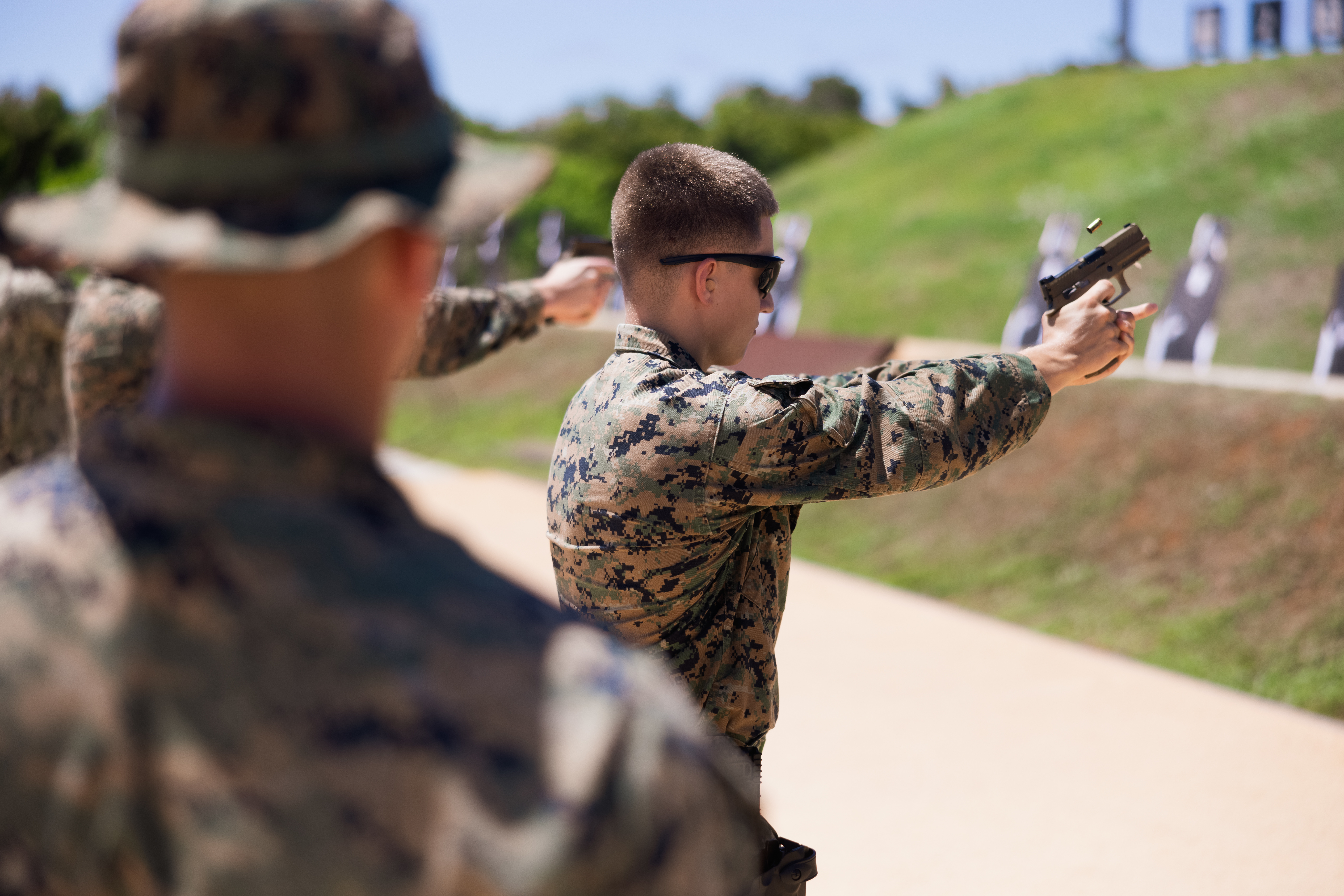 U.S. Marine Corps Cpl. Colin Downey, ground electronics transmission systems maintainer, Combat Logistics Company 34, Combat Logistics Regiment 37, 3rd Marine Logistics group, fires an M18 service pistol during a pistol range at Marine Corps Base Camp Blaz, Guam, April 23, 2025. This training was conducted to help familiarize the Marines with the weapon systems and improve their lethality. (U.S. Marine Corps photo by Cpl. Brayden Daniel)