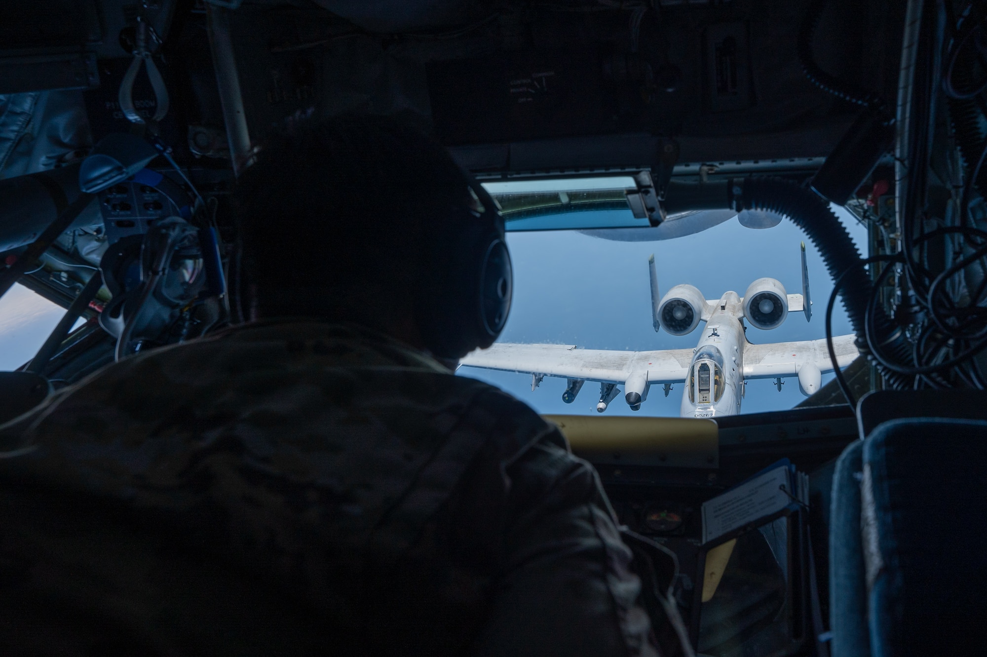 an A-10 aircraft approaches another aircraft before being refueled, view from inside the boom pod