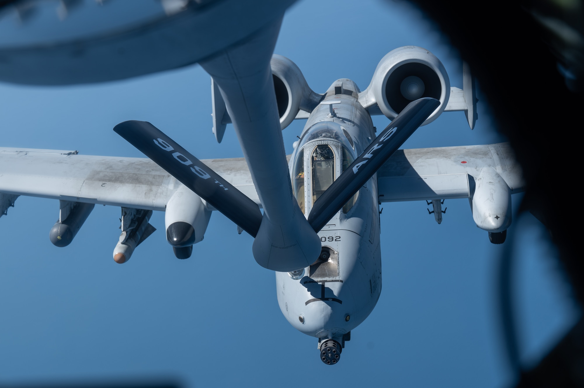 an A-10 aircraft gets refueled by another aircraft, view from inside the boom pod