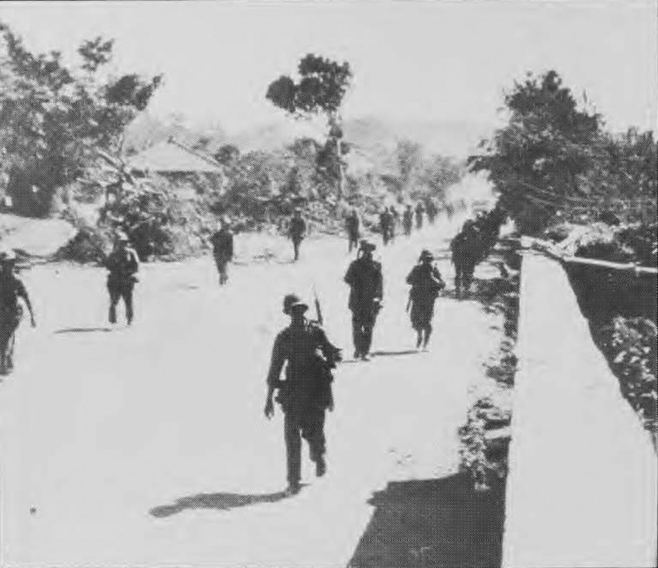 Engineers walk down the street in Post-War Okinawa, Japan