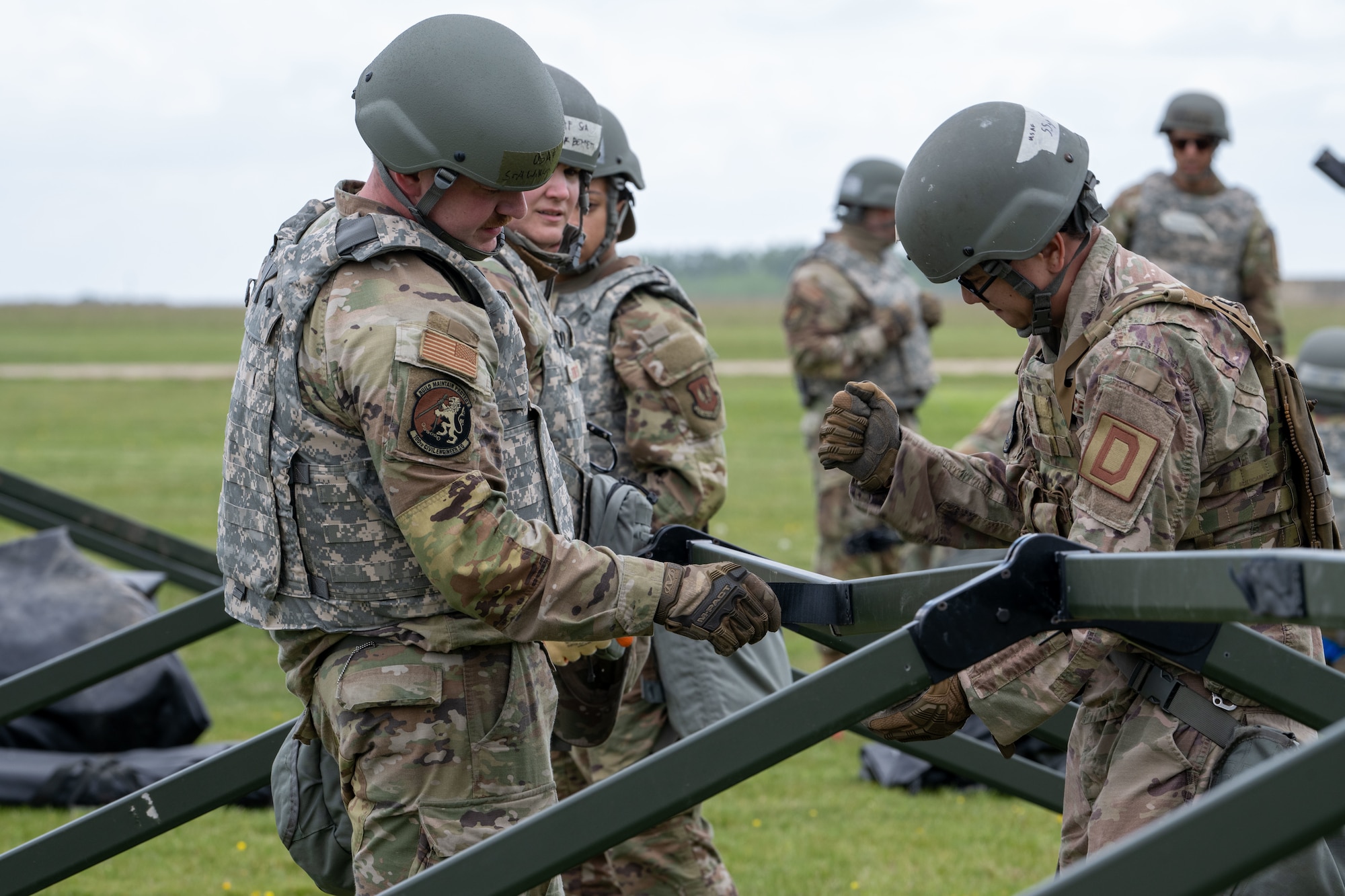 U.S. Airmen assigned to the 100th Civil Engineer Squadron work together to build temporary tents during a combat readiness inspection Skyway Chariot at RAF Feltwell, England, May 8, 2025.