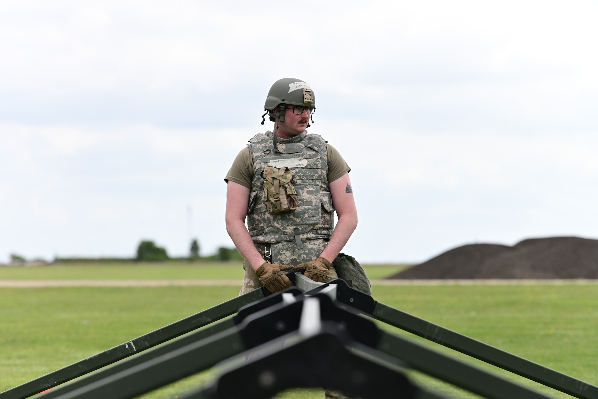 U.S. Air Force Senior Airman Cade Nut, 100th Civil Engineer Squadron, Heating, ventilation and air conditioning journeyman, sets up a temporary structure during a simulated deployment as part of combat readiness inspection Skyway Chariot at RAF Feltwell, England, May 8, 2025.