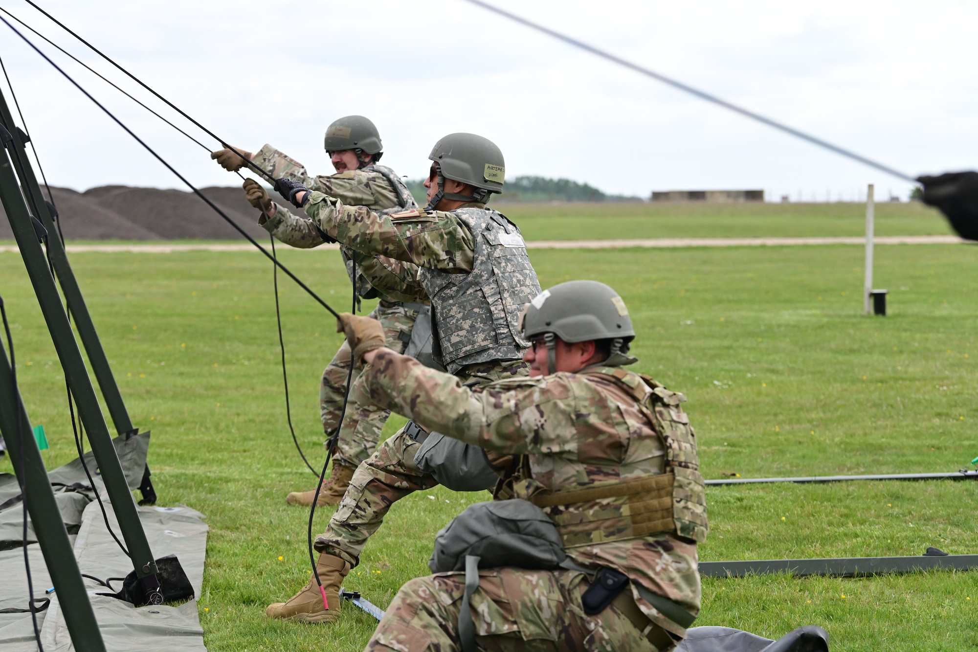 U.S. Airmen assigned to the 100th Civil Engineer Squadron put up a temporary tent as part of combat readiness inspection Skyway Chariot at RAF Feltwell, England, May 8, 2025.