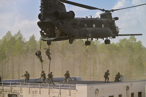 250404-N-BC658-2243 FORT BRAGG, NC (Apr. 04, 2025) U.S. Army Rangers assigned to the 75th Ranger Regiment fast rope off the back of a 160th Special Operations Aviation Regiment MH47 Chinook helicopter as part of an airborne assault demonstration during CAPEX2025 on Fort Bragg, North Carolina, April 3, 2025. Army special operations soldiers set the theater, enhancing local resistance, forcing the adversary into conducting protracted warfare, and extending the operational reach of conventional forces. (U.S. Navy photo by Mass Communication Specialist 1st Class Russell Lindsey SW/AW)