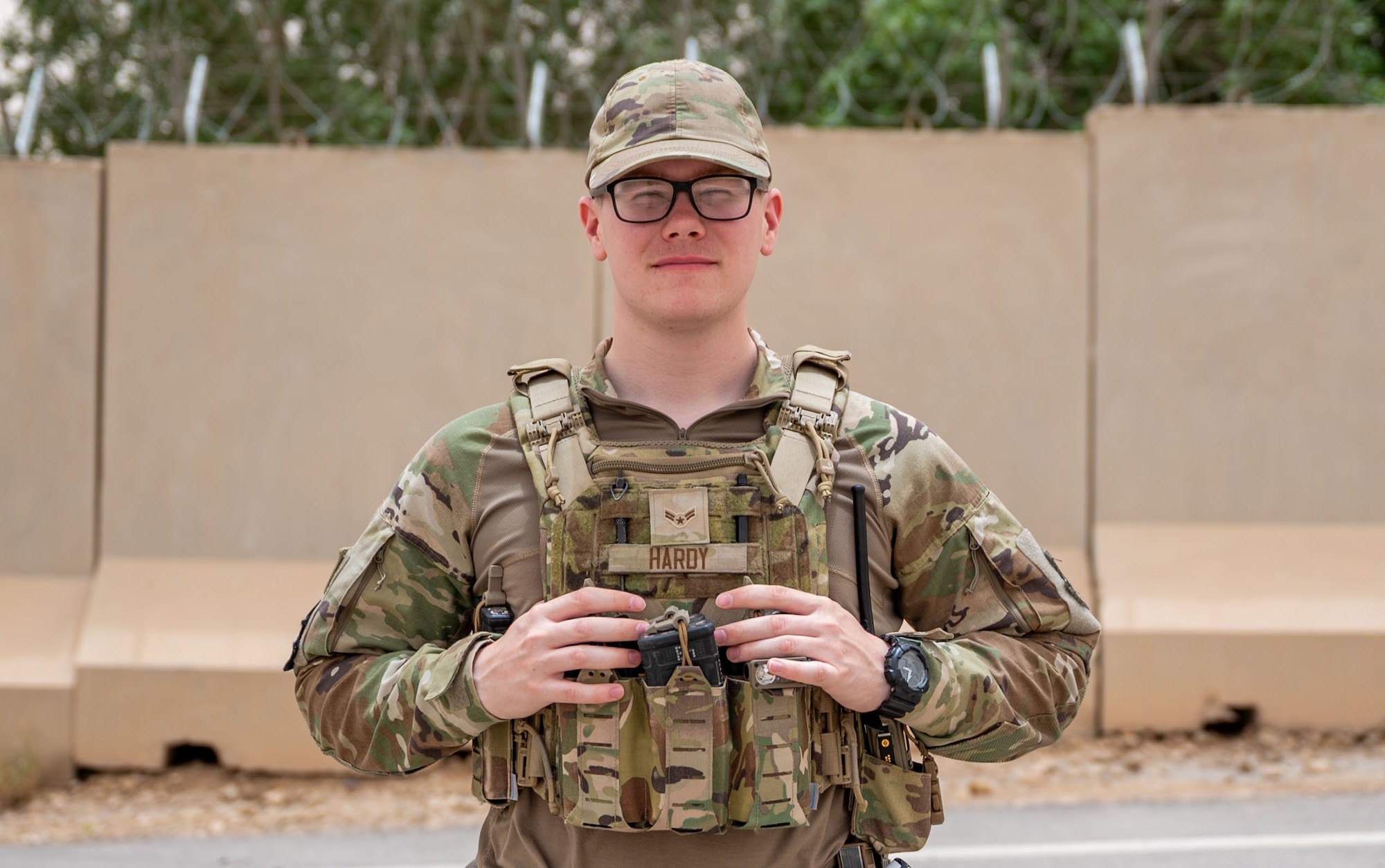 A Security Forces member poses with their hands on their tactical vest