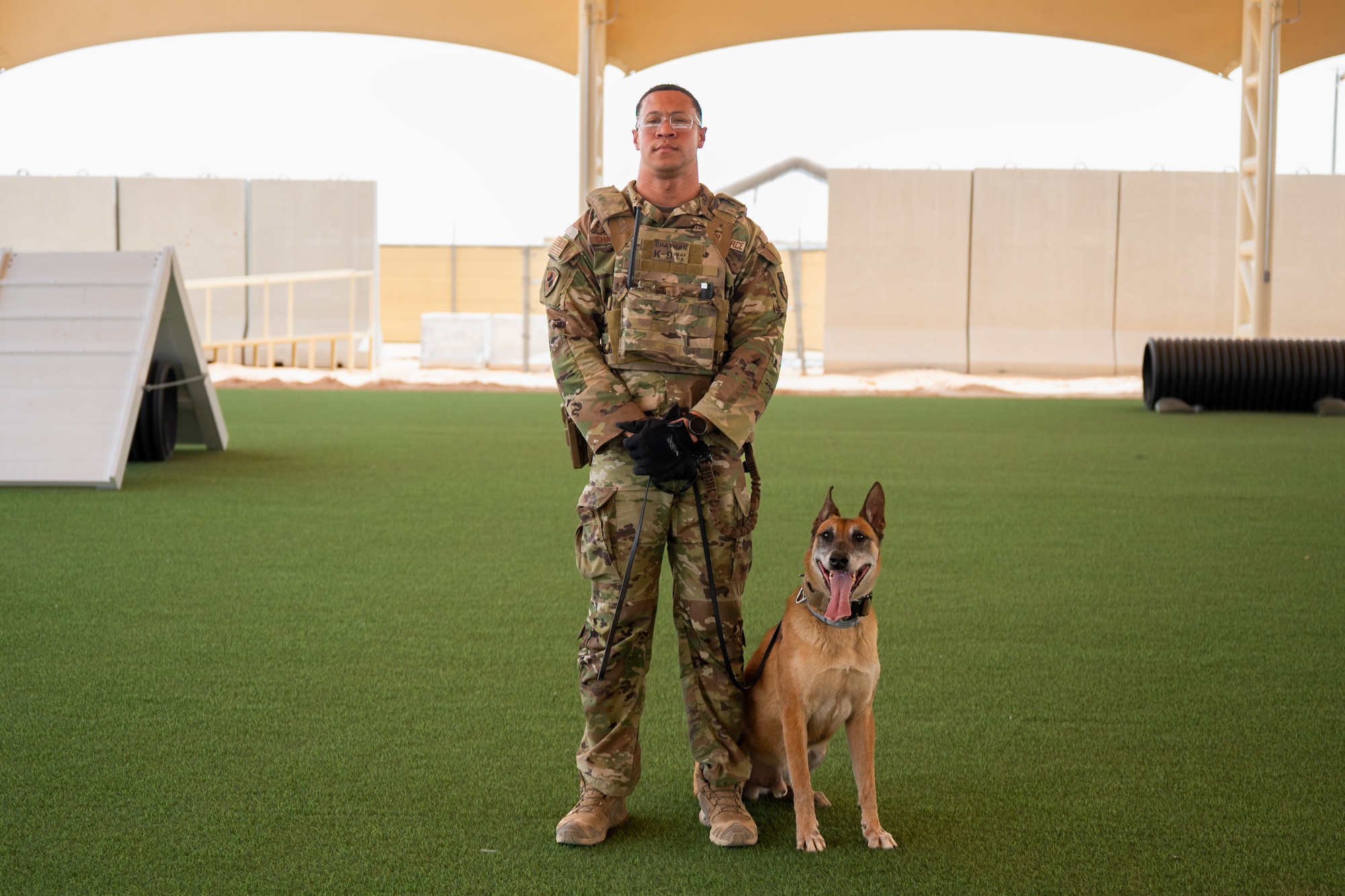 A Security Forces Airman poses with their Military Working Dog