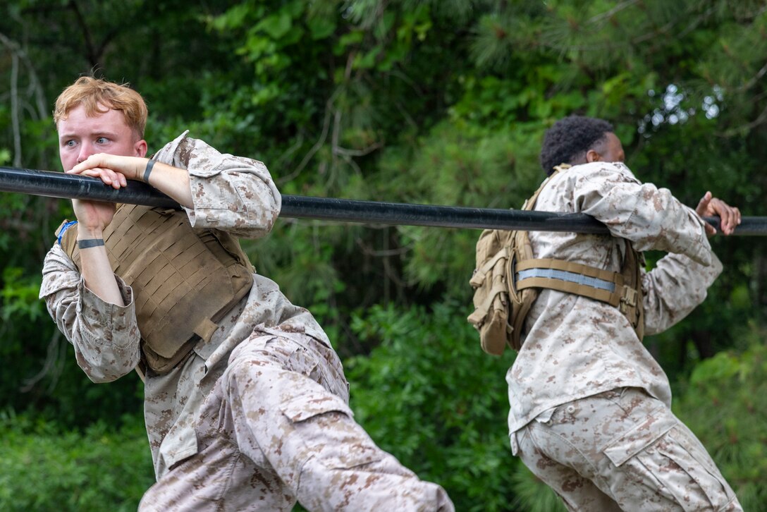 U.S. Marines participate in an obstacle course as part of a Martial Arts Instructor Course at Marine Corps Base Camp Lejeune, May 9, 2025. The MAI Course is a physically and mentally demanding three-week program designed to forge Marines into leaders who embody the warrior ethos, instill discipline, and teach others the values of MCMAP across II Marine Expeditionary Force and beyond. (U.S. Marine Corps photo by Lance Cpl. Isabella Ramos)
