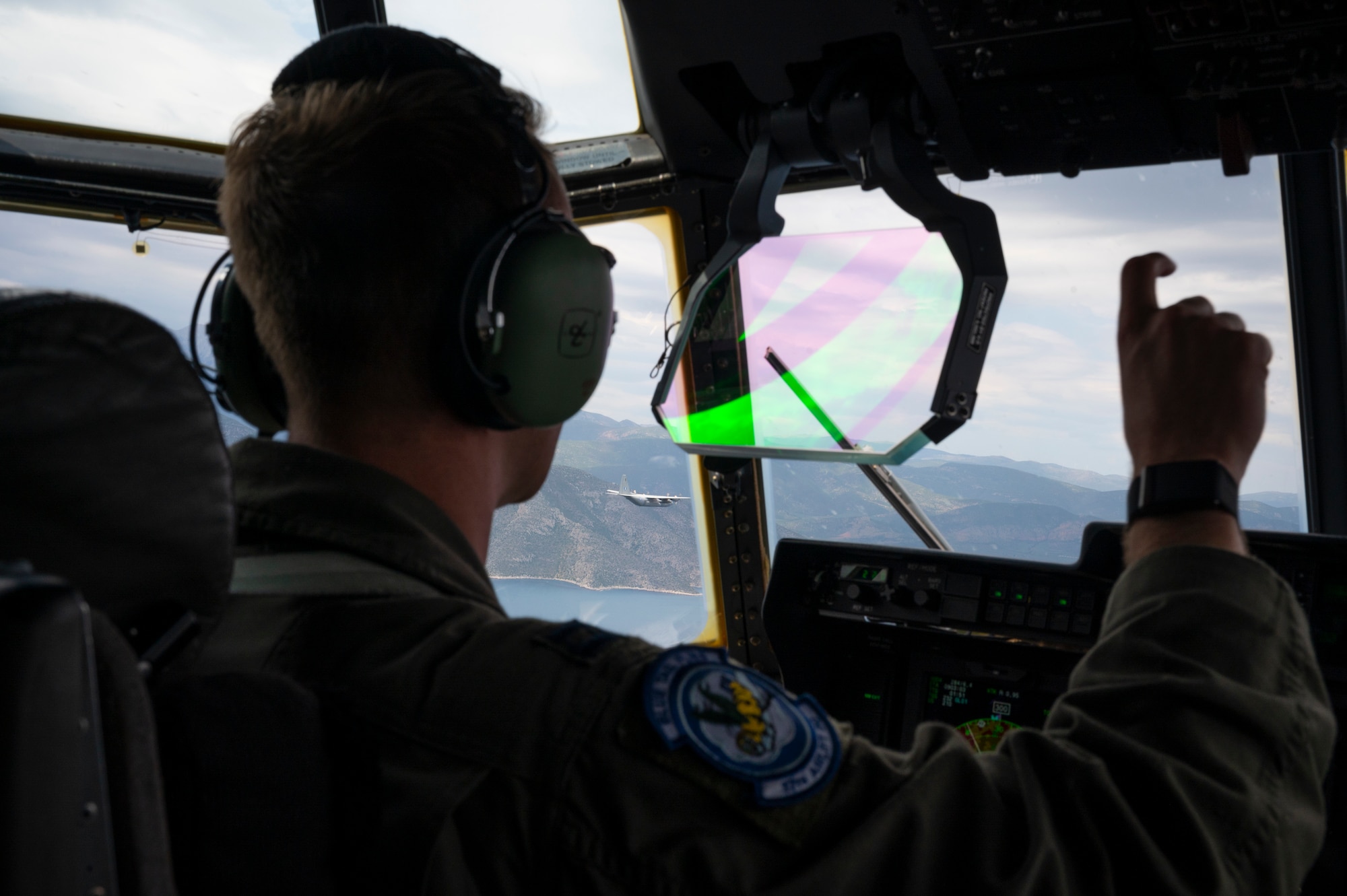 U.S. Air Force Capt. Weston Elias, 37th Airlift Squadron copilot, flies a C-130J Super Hercules over Greece in formation with a Hellenic Air Force C-130H Hercules during exercise Stolen Cerberus XII, April 29, 2025.
