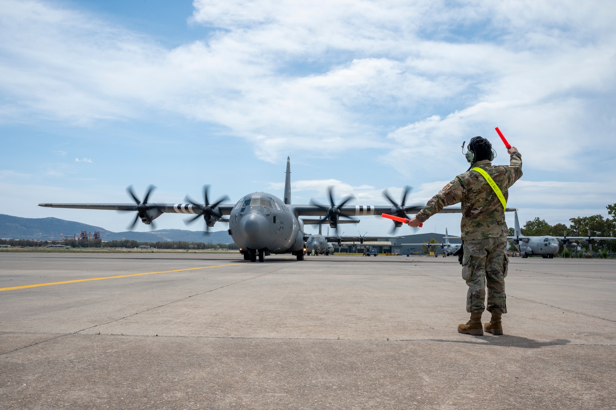 U.S. Air Force Airman 1st Class Tirtha Tripathi, 86th Maintenance Squadron crew chief, marshals a C-130J Super Hercules during exercise Stolen Cerberus XII at Elefsina Air Base, Greece, May 1, 2025.