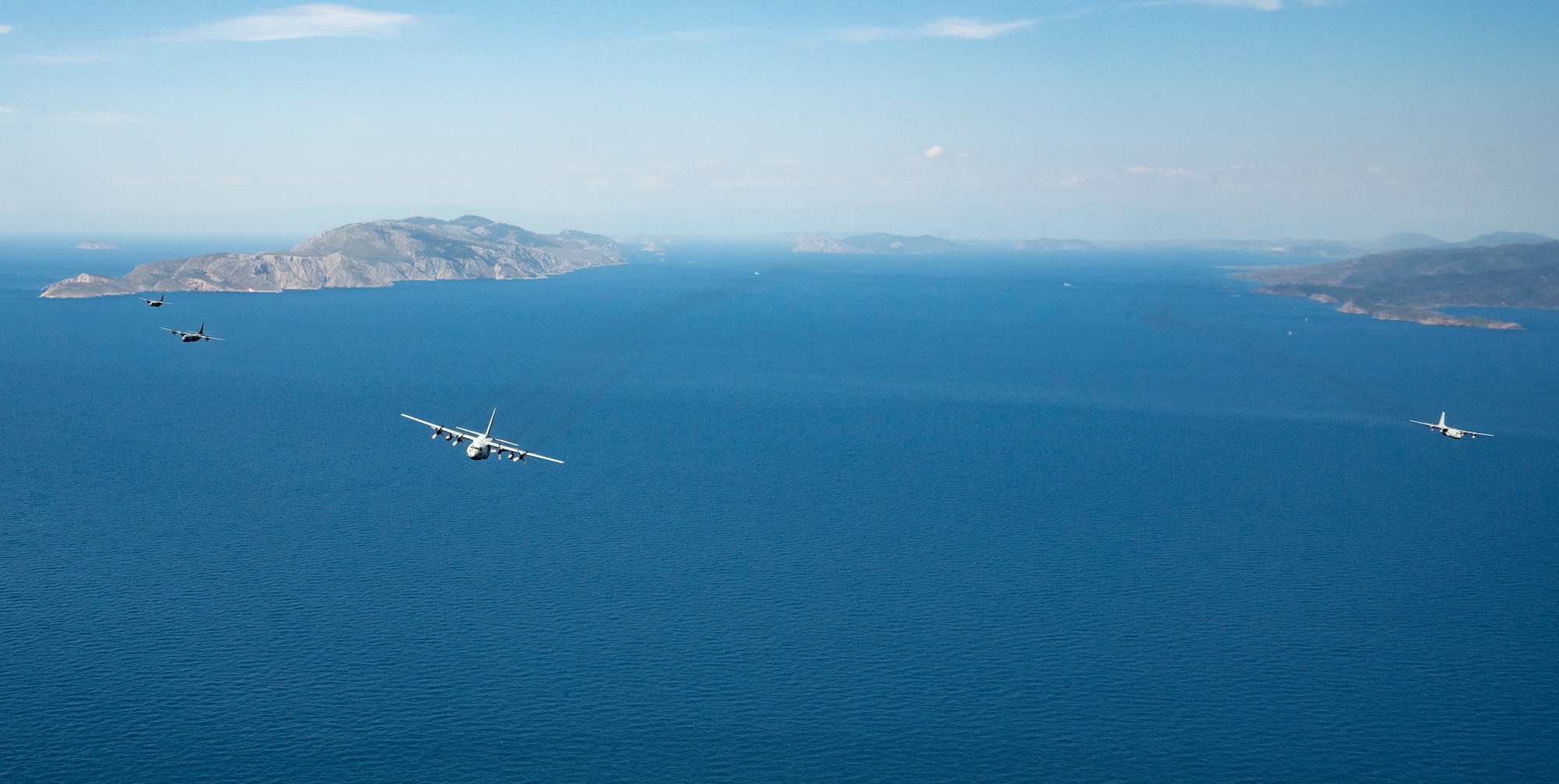 U.S. Air Force C-130J Super Hercules aircraft pilots, from the 37th Airlift Squadron fly in a five-plane formation with the Hellenic Air Force over the Saronic Gulf, Greece, during Stolen Cerberus XII May 2, 2025.