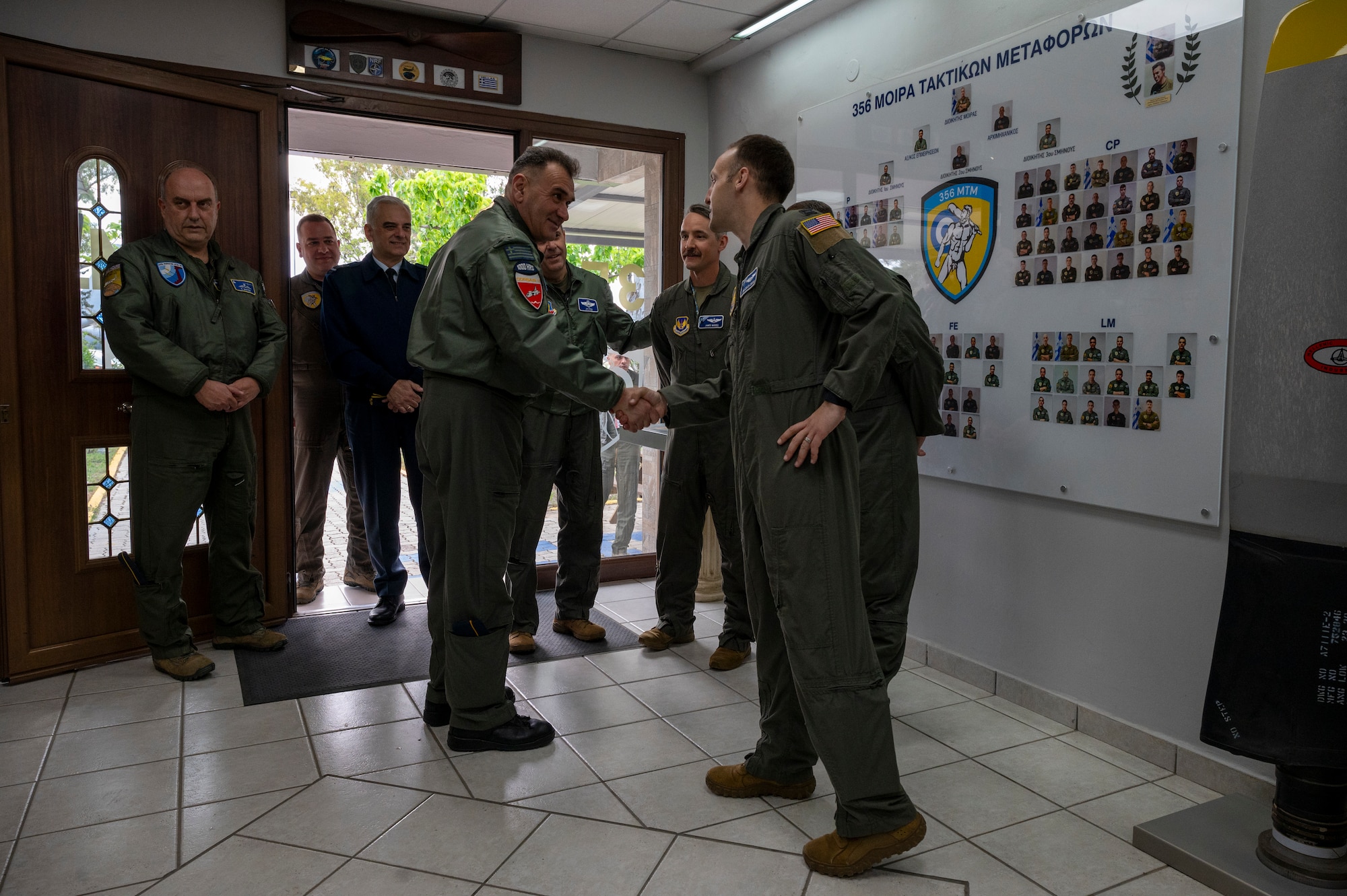 U.S. Air Force Capt. Eric Zielen-Ersing, 37th Airlift Squadron Stolen Cerberus mission commander, greets Hellenic Air Force Maj. Gen. Vasileios Broumas, Hellenic Air Force Support Command commander, during exercise Stolen Cerberus XII at Elefsina Air Base, Greece, May 2, 2025.