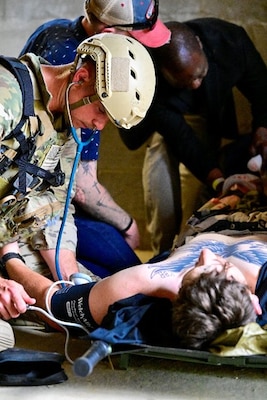 250404-N-BC658-1997 FORT BRAGG, NC (Apr. 04, 2025) A special operations medic of the U.S. Army John F. Kennedy Special Warfare Center and School's; Joint Special Operations Medical Training Center (JSOMTC) treats a simulated patient during a mass casualty event demonstration during the CAPEX2025 exercise on Fort Bragg, North Carolina, April 4, 2025. JSOMTC provides world-class medical and skills training to special operations medical personnel of the Army, Navy and Marine Corps. (U.S. Navy photo by Mass Communication Specialist 1st Class Russell Lindsey SW/AW)