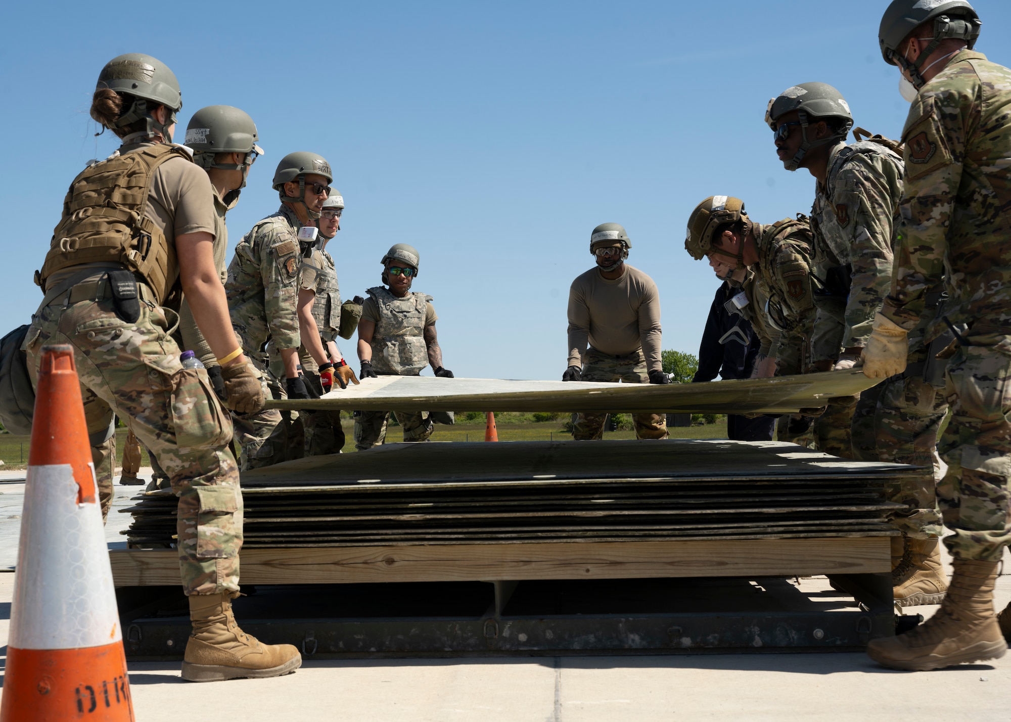 U.S. Airmen assigned to the 100th Civil Engineer Squadron move emergency flight line repair equipment during combat readiness inspection Skyway Chariot at RAF Feltwell, England, May 9, 2025.