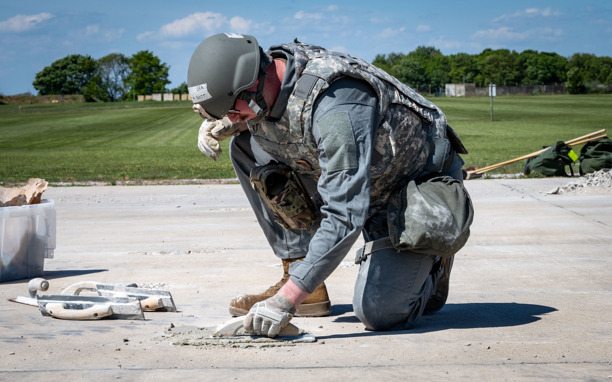 A U.S. Airman assigned to the 100th Civil Engineer Squadron uses a cement scraper to make repairs to the damaged runway during combat readiness inspection Skyway Chariot at RAF Feltwell, England, May 9, 2025.