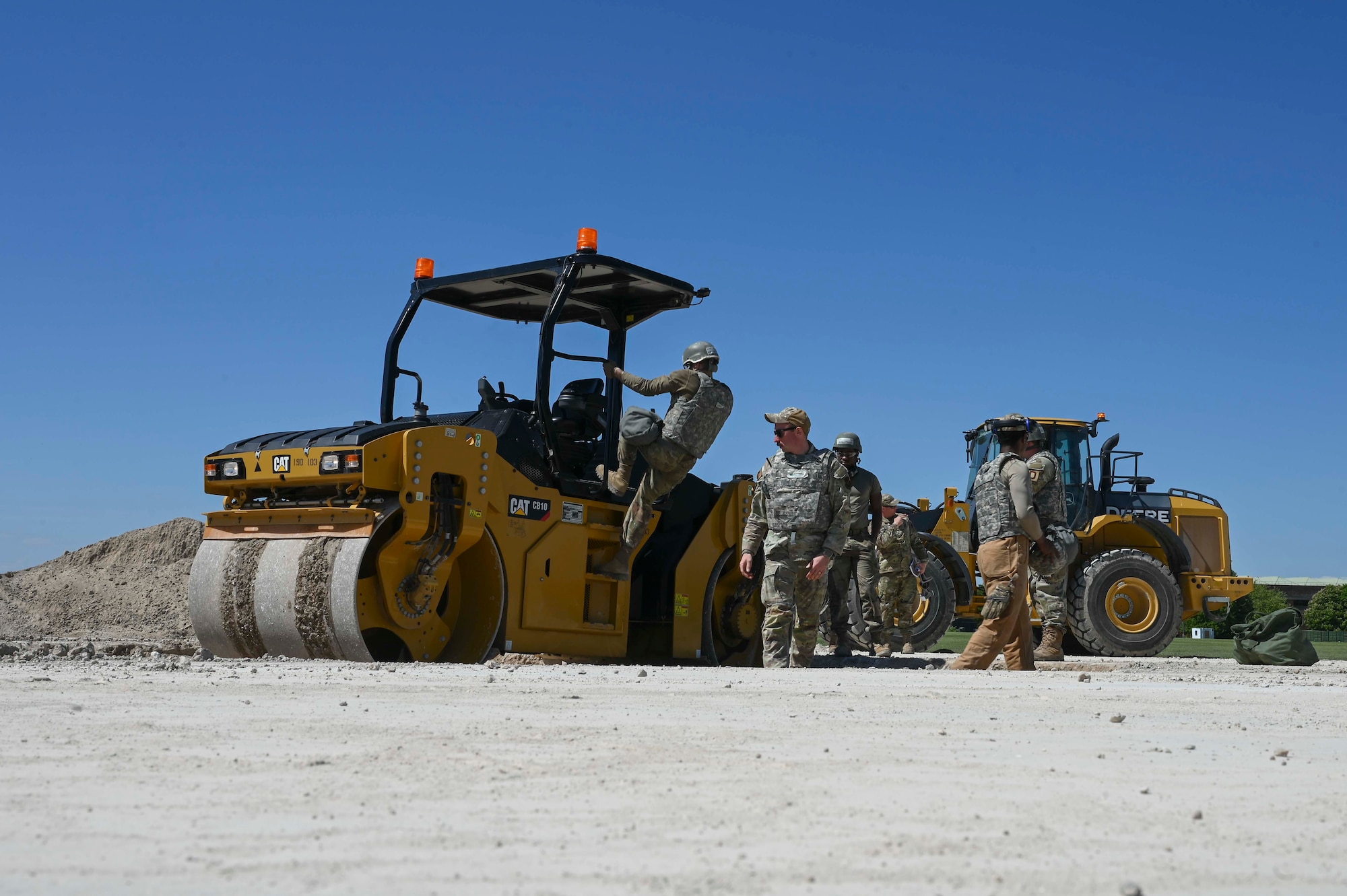 U.S. Airmen assigned to the 100th Civil Engineer Squadron flatten the ground creating a foundation to build an operational flight line during combat readiness inspection Skyway Chariot at RAF Feltwell, England, May 9, 2025.