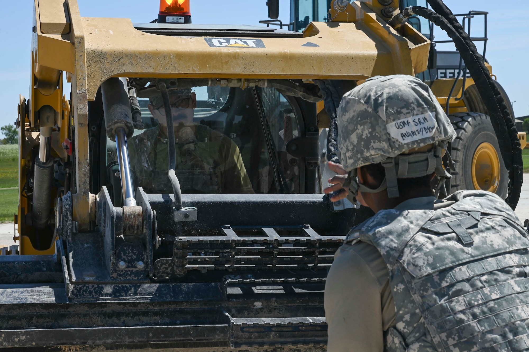 U.S. Airmen assigned to the 100th Civil Engineer Squadron fill a hole with dirt creating a foundation to build an operational flight line during combat readiness inspection Skyway Chariot at RAF Feltwell, England, May 9, 2025.